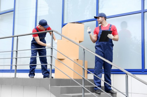 Chelsea removals team handling boxes during a residential move
